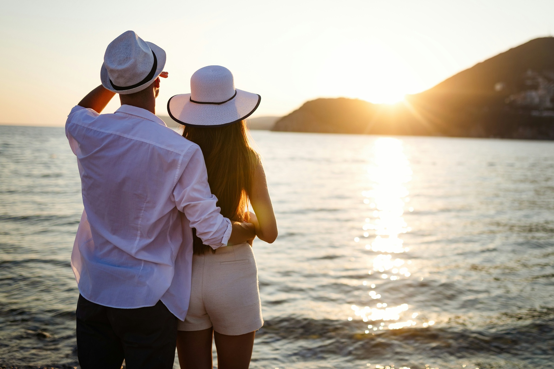 Couple watching sunset over the ocean